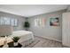 Bright bedroom with two windows, plant accents, and neutral color palette at 5582 Baywater Dr, Tampa, FL 33615
