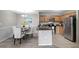 Kitchen and dining area with stainless steel appliances, wood cabinets, granite countertop and a black table at 5582 Baywater Dr, Tampa, FL 33615