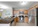 Kitchen featuring stainless steel appliances, wooden cabinets, granite countertops, and a serving counter at 5582 Baywater Dr, Tampa, FL 33615