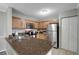 Kitchen with stainless steel appliances, wood cabinets, granite countertop, and tile flooring at 5582 Baywater Dr, Tampa, FL 33615