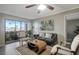 Bright living room featuring a cozy seating arrangement and sliding door to outdoor area at 5582 Baywater Dr, Tampa, FL 33615
