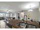 Open concept living space with modern appliances, wood cabinets, granite counters, and stylish furniture at 5582 Baywater Dr, Tampa, FL 33615