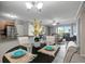 Open floorplan showcasing the dining area flowing into the living room, kitchen with granite counters, and stainless appliances at 5582 Baywater Dr, Tampa, FL 33615