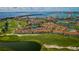 Stunning aerial view of a golf course community with waterfront homes, lush greenery, and a scenic bridge in the background at 6151 Bahia Del Mar Blvd # 126, St Petersburg, FL 33715