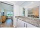 Bathroom vanity with granite counters reflects the bedroom and living area at 6151 Bahia Del Mar Blvd # 126, St Petersburg, FL 33715