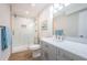 Modern bathroom features white marble shower and gray vanity with quartz countertop at 6151 Bahia Del Mar Blvd # 126, St Petersburg, FL 33715