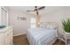 Cozy bedroom with ceiling fan, wood floors, and charming St. Pete Beach decor at 6151 Bahia Del Mar Blvd # 126, St Petersburg, FL 33715