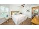 Bright bedroom with wood floors, white walls, and a glimpse into the ensuite bathroom at 6151 Bahia Del Mar Blvd # 126, St Petersburg, FL 33715