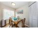 Bright dining area with a glass-top table, woven chairs, and views from a large window at 6151 Bahia Del Mar Blvd # 126, St Petersburg, FL 33715