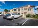 Inviting two-story condo building with a red tile roof, lush landscaping and convenient parking at 6151 Bahia Del Mar Blvd # 126, St Petersburg, FL 33715