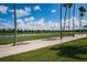Scenic golf course view with lush green grass, sandy areas, tall palm trees and a blue sky at 6151 Bahia Del Mar Blvd # 126, St Petersburg, FL 33715