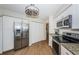 Bright kitchen with stainless steel appliances, granite countertops, white cabinets, and wood flooring at 6151 Bahia Del Mar Blvd # 126, St Petersburg, FL 33715