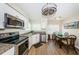 Bright kitchen open to the dining area with stainless steel appliances and modern finishes at 6151 Bahia Del Mar Blvd # 126, St Petersburg, FL 33715