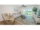 Relaxing living room includes a ceiling fan, comfortable sofa, recliner, and sliding glass doors overlooking the property at 6151 Bahia Del Mar Blvd # 126, St Petersburg, FL 33715