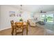 Inviting living room featuring wood floors, dining area, comfortable seating, and a sliding door to outdoor space at 6151 Bahia Del Mar Blvd # 126, St Petersburg, FL 33715