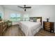Bright main bedroom with two windows showing lake views, a ceiling fan, and warm furniture at 6151 Bahia Del Mar Blvd # 126, St Petersburg, FL 33715