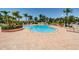 Large swimming pool with lounge chairs surrounded by lush tropical landscaping at 6151 Bahia Del Mar Blvd # 126, St Petersburg, FL 33715