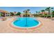 Beautiful community pool area surrounded by lounge chairs and lush landscaping at 6151 Bahia Del Mar Blvd # 126, St Petersburg, FL 33715