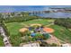 Aerial view showcasing the community baseball fields, surrounded by trees and water at 670 Wooddell Dr, Safety Harbor, FL 34695