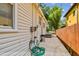 Backyard featuring a green garden hose and a grill along the side of the home at 670 Wooddell Dr, Safety Harbor, FL 34695
