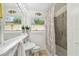 Bright bathroom featuring tiled walls, a mirror, updated fixtures, and a window for natural light at 670 Wooddell Dr, Safety Harbor, FL 34695