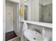 Bathroom features updated fixtures, sink, and shower with floor to ceiling tile at 670 Wooddell Dr, Safety Harbor, FL 34695