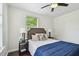 Cozy bedroom featuring a ceiling fan, stylish lamps, and soft neutral decor at 670 Wooddell Dr, Safety Harbor, FL 34695