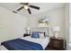 Charming bedroom with ceiling fan and bedside lamps flanking tufted headboard at 670 Wooddell Dr, Safety Harbor, FL 34695