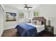 Cozy bedroom with hardwood floors, neutral walls, windows for natural light, and contemporary furnishings at 670 Wooddell Dr, Safety Harbor, FL 34695