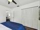 Bedroom featuring a spacious closet, doorway, hardwood floors, and ceiling fan at 670 Wooddell Dr, Safety Harbor, FL 34695