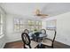 Cozy dining area featuring a round table, four chairs, and natural light streaming through the plantation-shuttered windows at 670 Wooddell Dr, Safety Harbor, FL 34695