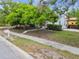 Well-kept single Gathering home with mature trees and a manicured front yard at 670 Wooddell Dr, Safety Harbor, FL 34695