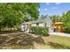 Charming home with white siding, a palm tree in the front yard, and green hedges at 670 Wooddell Dr, Safety Harbor, FL 34695
