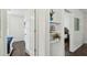 Bright hallway with decorative shelving leading to bedrooms with wood floors at 670 Wooddell Dr, Safety Harbor, FL 34695