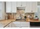 Kitchen features a stainless sink, tile backsplash, and wooden countertops at 670 Wooddell Dr, Safety Harbor, FL 34695