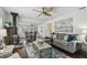 Open-concept living room with a wood-burning stove, dining area, hardwood floors, and stylish furnishings at 670 Wooddell Dr, Safety Harbor, FL 34695