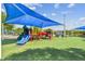 Colorful playground area with slides, climbing structures, and a covered area for shade at 670 Wooddell Dr, Safety Harbor, FL 34695