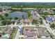 Aerial view of a well-maintained home in a beautiful community with lush landscaping and a serene lake at 7004 Westminster St, Tampa, FL 33635