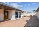 Inviting brick patio with comfortable seating and a sliding glass door to the home at 7004 Westminster St, Tampa, FL 33635