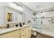 Bright bathroom with dual sinks, stylish vanity, glass-enclosed shower, and contemporary finishes for a luxurious feel at 7004 Westminster St, Tampa, FL 33635