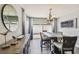 Bright dining area with stylish table, elegant lighting, tasteful decor, and sliding doors to the backyard at 7004 Westminster St, Tampa, FL 33635