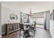 Dining area with modern table, elegant lighting, stylish furniture, and sliding doors to the outside patio at 7004 Westminster St, Tampa, FL 33635