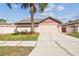 Charming single-story home with a well-maintained lawn, complemented by a freshly sealed driveway at 7004 Westminster St, Tampa, FL 33635