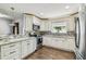 Charming kitchen with stainless appliances, granite countertops, and breakfast bar at 7004 Westminster St, Tampa, FL 33635