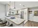 Well-lit kitchen with stainless steel refrigerator, ample cabinets, and stylish bar top seating at 7004 Westminster St, Tampa, FL 33635