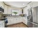 Modern kitchen with stainless steel appliances, granite countertops, and custom cabinetry at 7004 Westminster St, Tampa, FL 33635