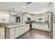 Open kitchen with bar seating, stainless appliances and custom cabinets at 7004 Westminster St, Tampa, FL 33635