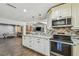 Open-concept kitchen boasts granite countertops, stainless steel appliances, stylish cabinets, and seamless flow to living areas at 7004 Westminster St, Tampa, FL 33635