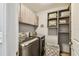 Functional laundry room with storage shelves and cabinets offering practical space and modern appliances at 7004 Westminster St, Tampa, FL 33635