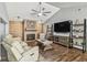 Cozy living room features a stylish brick fireplace, vaulted ceilings, and modern decor on wood-look floors at 7004 Westminster St, Tampa, FL 33635